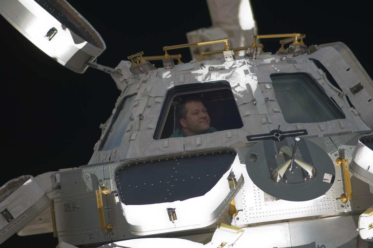 STS 130 Nicholas Patrick looks through Cupola